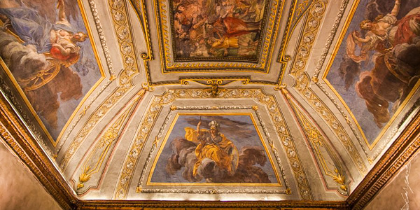 The frescoed ceiling in one of the dining rooms at L'Eau Vive
