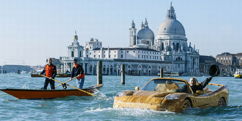 Artist Livio De Marchi driving his hand-made wooden Ferrari in the Bacino San Marco..