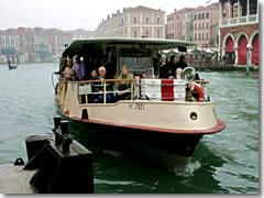 A vaporetto, the Venetian water bus or public ferry, arriving on the Grand Canal in Venice