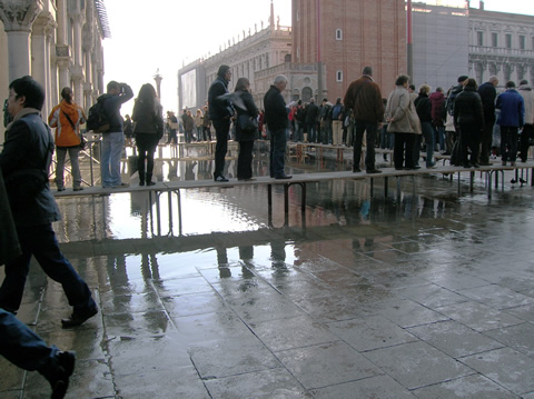 Even when the flood waters are barely beginning to creep over the paving stones of the city, the entrance to the Basilica di San Marco is already underwater and tourists have to line up along boardwalks.